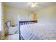 Bright bedroom showcasing a comfortable chair, double closets, and a large bed at 5417 Kerns Ln, Indianapolis, IN 46268