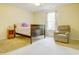 Comfortable bedroom showcasing natural light, plush chair, and hardwood bed frame at 5417 Kerns Ln, Indianapolis, IN 46268