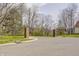 Gated community entrance with brick pillars surrounded by well-manicured lawns at 5417 Kerns Ln, Indianapolis, IN 46268