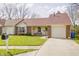 Charming one-story home featuring a well-manicured lawn, brick accents, and an attached garage at 5417 Kerns Ln, Indianapolis, IN 46268