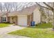 Attached one-car garage featuring brick accents, a white door, and easy driveway access at 5417 Kerns Ln, Indianapolis, IN 46268