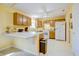 Bright kitchen with oak cabinets, white appliances, and a functional layout at 5417 Kerns Ln, Indianapolis, IN 46268