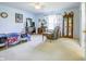 Spacious main bedroom features a ceiling fan, natural light, and a comfortable sitting area for relaxation at 5417 Kerns Ln, Indianapolis, IN 46268