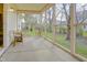 Open screened porch with views of the lush lawn and mature trees at 5417 Kerns Ln, Indianapolis, IN 46268