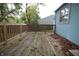 Wooden back deck offers outdoor living space with a railing, overlooking the yard and connecting to the house at 5707 W Mills Rd, Indianapolis, IN 46221