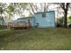 Light blue house with a wooden deck and well-maintained lawn at 5707 W Mills Rd, Indianapolis, IN 46221