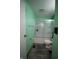 Clean bathroom featuring a shower-tub combo with sliding glass door and wood look flooring at 5707 W Mills Rd, Indianapolis, IN 46221