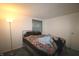 Cozy bedroom featuring a metal bedframe, window, and a neutral-toned color scheme, offering a tranquil personal space at 5707 W Mills Rd, Indianapolis, IN 46221