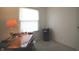 Bright home office or bedroom with lots of natural light from the window and carpeted flooring at 5707 W Mills Rd, Indianapolis, IN 46221