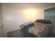 Bedroom featuring a metal bedframe, window, and a neutral-toned color scheme, offering a tranquil personal space at 5707 W Mills Rd, Indianapolis, IN 46221