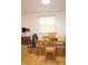 Bright dining area with hardwood floors and a wooden dining table and chairs near a window at 5707 W Mills Rd, Indianapolis, IN 46221