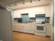 Well-lit kitchen featuring stainless steel appliances and eye-catching blue tile backsplash at 5707 W Mills Rd, Indianapolis, IN 46221
