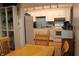 Kitchen features white cabinets, blue backsplash, and stainless steel appliances next to the dining room at 5707 W Mills Rd, Indianapolis, IN 46221