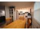 Kitchen features white cabinets, blue backsplash, and stainless steel appliances viewed from the dining room at 5707 W Mills Rd, Indianapolis, IN 46221