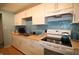 Bright kitchen featuring white cabinetry, butcher block countertops, and modern appliances at 5707 W Mills Rd, Indianapolis, IN 46221