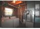 Functional laundry area in the basement features a washer, dryer, and utilities, maximizing space and efficiency at 5707 W Mills Rd, Indianapolis, IN 46221