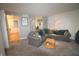Comfortable living room with neutral carpet, modern lighting, and a large sectional sofa at 5707 W Mills Rd, Indianapolis, IN 46221