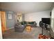 Comfortable living room with neutral carpet, modern lighting, and a large sectional sofa at 5707 W Mills Rd, Indianapolis, IN 46221