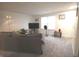 Bright living room with neutral carpet, modern lighting, a large sectional sofa, and a TV at 5707 W Mills Rd, Indianapolis, IN 46221