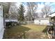 Spacious backyard featuring a chain-link fence, partial grass coverage, and a detached garage in a residential area at 5718 E Pleasant Run Parkway North Dr, Indianapolis, IN 46219