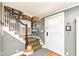 Inviting foyer featuring hardwood floors, staircase with decorative carpet runner, and an array of framed photographs at 5718 E Pleasant Run Parkway North Dr, Indianapolis, IN 46219