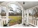Charming front porch with decorative archway and view of the surrounding landscape at 5718 E Pleasant Run Parkway North Dr, Indianapolis, IN 46219