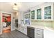 Kitchen features a large farmhouse sink, stainless steel dishwasher and a tile floor at 5718 E Pleasant Run Parkway North Dr, Indianapolis, IN 46219