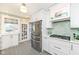 Well lit kitchen features stainless steel refrigerator and a tile floor at 5718 E Pleasant Run Parkway North Dr, Indianapolis, IN 46219