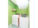 Laundry room area with white appliances, green walls, and unique patterned floors at 5718 E Pleasant Run Parkway North Dr, Indianapolis, IN 46219