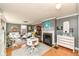 Bright and airy living room with hardwood floors, a fireplace, and stylish decor creating a comfortable atmosphere at 5718 E Pleasant Run Parkway North Dr, Indianapolis, IN 46219