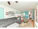 The living room has a gray couch and lots of windows at 5718 E Pleasant Run Parkway North Dr, Indianapolis, IN 46219