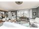 Bright living room with large bay window, hardwood floors, and stylish decor at 5718 E Pleasant Run Parkway North Dr, Indianapolis, IN 46219
