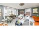 Cozy living room featuring a bay window, hardwood floors, and comfortable seating at 5718 E Pleasant Run Parkway North Dr, Indianapolis, IN 46219