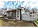 Delightful backyard outbuilding with charming details, including a white picket fence, flower boxes, and a gated entrance at 5718 E Pleasant Run Parkway North Dr, Indianapolis, IN 46219