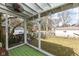 Relaxing screened porch offering views of the backyard with mature trees and green grass at 5718 E Pleasant Run Parkway North Dr, Indianapolis, IN 46219