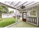 Inviting screened porch with view of the backyard and surrounding neighborhood at 5718 E Pleasant Run Parkway North Dr, Indianapolis, IN 46219