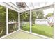 Relaxing screened porch offering an outdoor space with views of the garden, yard and neighborhood at 5718 E Pleasant Run Parkway North Dr, Indianapolis, IN 46219