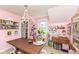 Bright studio space with a chandelier, craft supplies, and natural light from windows at 5718 E Pleasant Run Parkway North Dr, Indianapolis, IN 46219