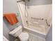 Clean bathroom featuring a shower-tub combo with safety bars, and a low-flow toilet, perfect for accessibility at 5989 Ashmore Ln, Carmel, IN 46033