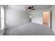 Bright bedroom with soft gray carpet and a walk-in closet at 5989 Ashmore Ln, Carmel, IN 46033