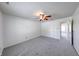 Spacious bedroom featuring neutral carpet, ceiling fan, and access to other rooms at 5989 Ashmore Ln, Carmel, IN 46033