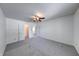 Bright bedroom with gray carpet, ceiling fan, and large closet for ample storage at 5989 Ashmore Ln, Carmel, IN 46033