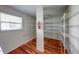 Spacious walk-in closet with built-in shelving and hardwood floors at 5989 Ashmore Ln, Carmel, IN 46033