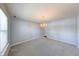 Dining area with plush carpeting, classic lighting, and natural light from the windows at 5989 Ashmore Ln, Carmel, IN 46033