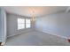 Bright dining area featuring plush carpeting and an elegant chandelier fixture at 5989 Ashmore Ln, Carmel, IN 46033