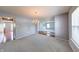 Spacious dining room featuring modern paint, carpet and a classic chandelier fixture at 5989 Ashmore Ln, Carmel, IN 46033