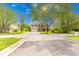 Two-story home featuring brick and vinyl siding, an attached garage, a long driveway, and mature trees at 5989 Ashmore Ln, Carmel, IN 46033