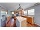 Kitchen boasts stainless steel appliances, an island, and light wood cabinets at 5989 Ashmore Ln, Carmel, IN 46033