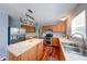 Kitchen features stainless appliances, island, and classic wood cabinets and flooring at 5989 Ashmore Ln, Carmel, IN 46033