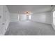 Expansive living room with cozy carpet, ceiling fan, and ample lighting, great for entertaining and relaxation at 5989 Ashmore Ln, Carmel, IN 46033